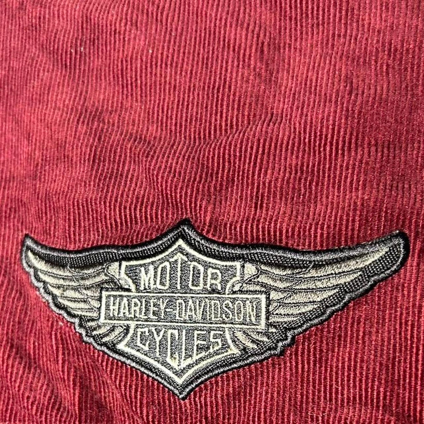 Harley Davidson patch logo on a maroon background