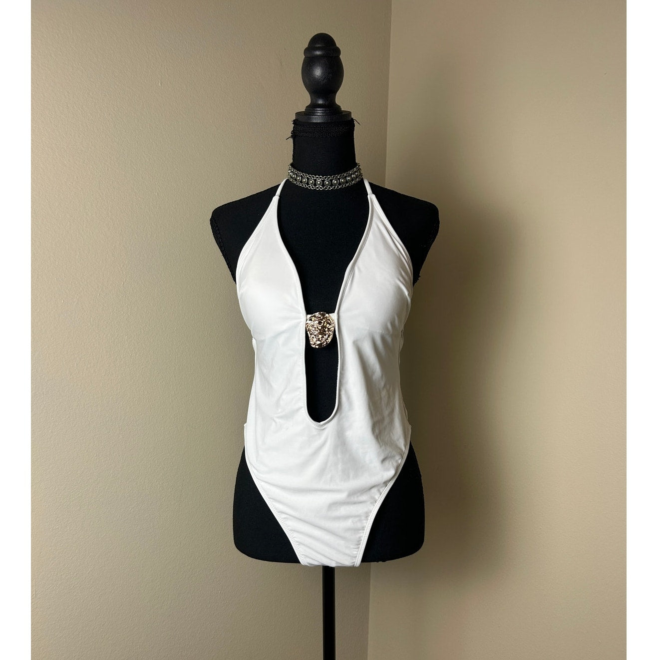white plunge neck one piece bathing suit open back high leg shell accent