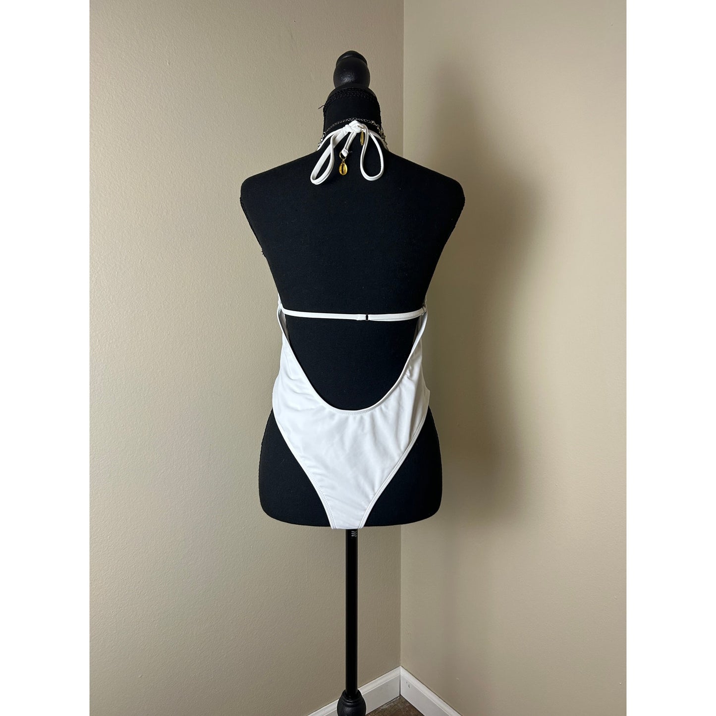 white plunge neck one piece bathing suit open back high leg shell accent