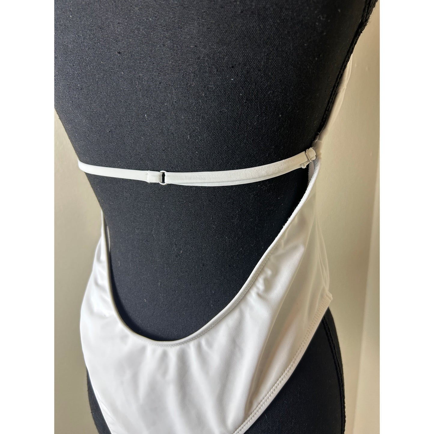 white plunge neck one piece bathing suit open back high leg shell accent